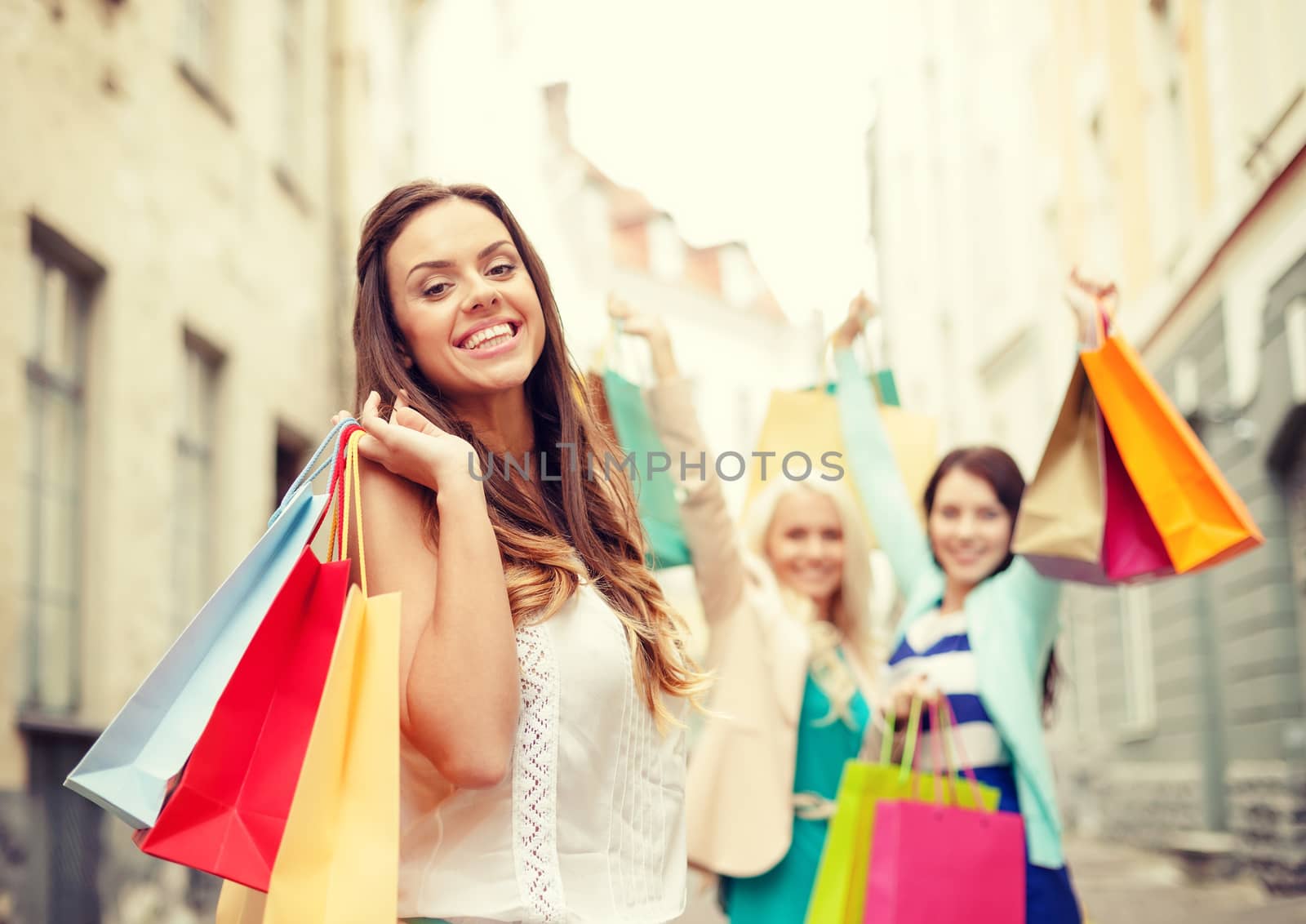 sale, shopping, tourism and happy people concept - beautiful woman with shopping bags in the ctiy