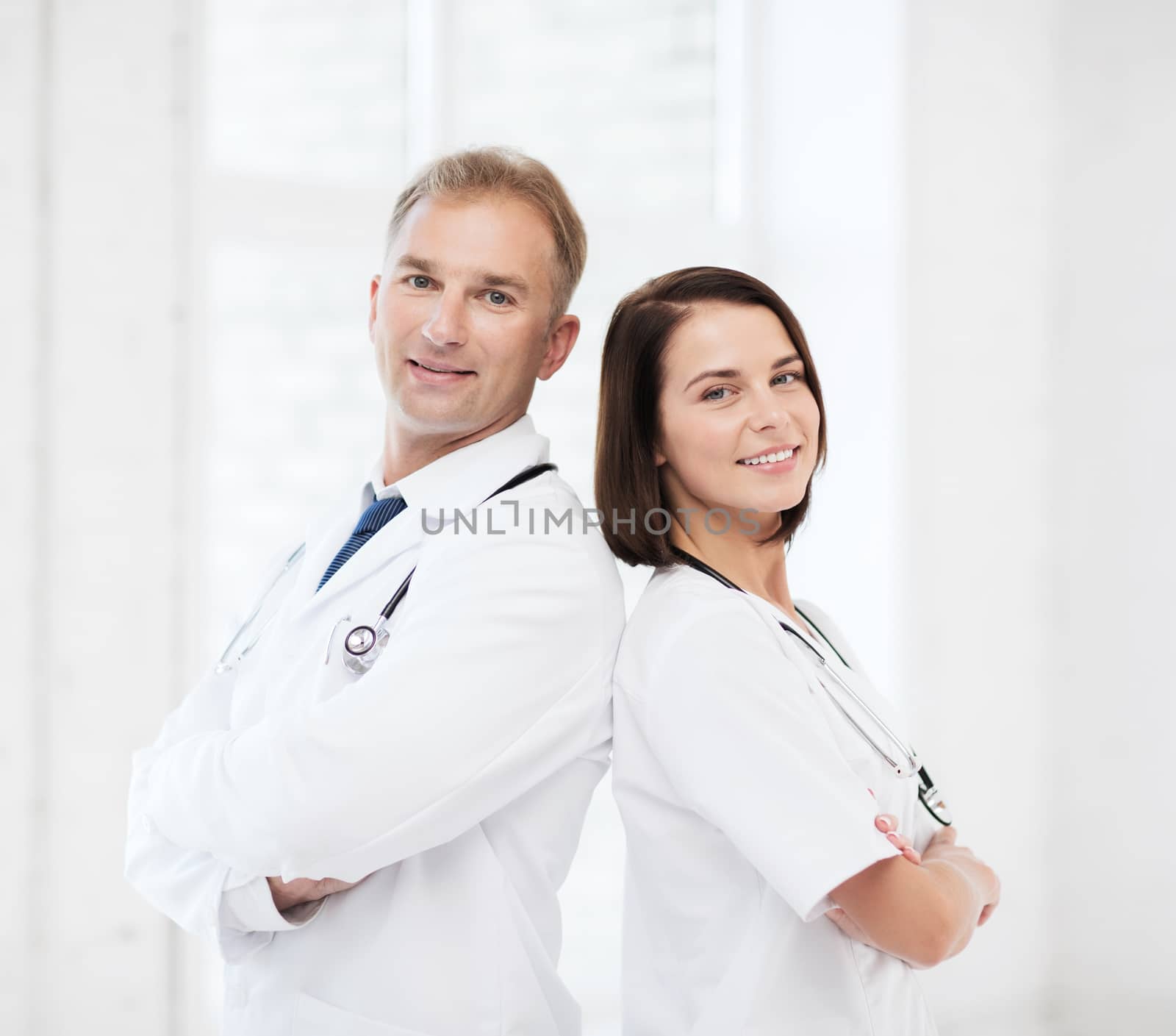 two doctors with stethoscopes by dolgachov