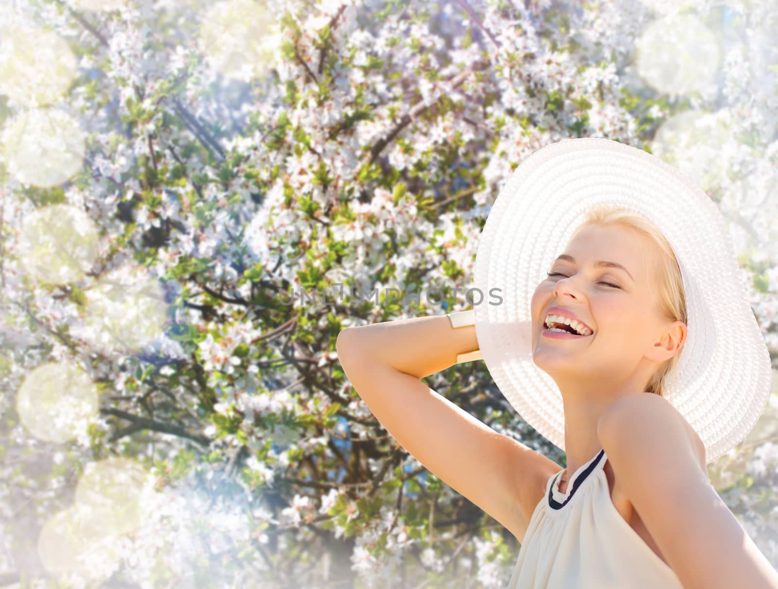 fashion, happiness and lifestyle concept - beautiful woman in hat enjoying summer outdoors