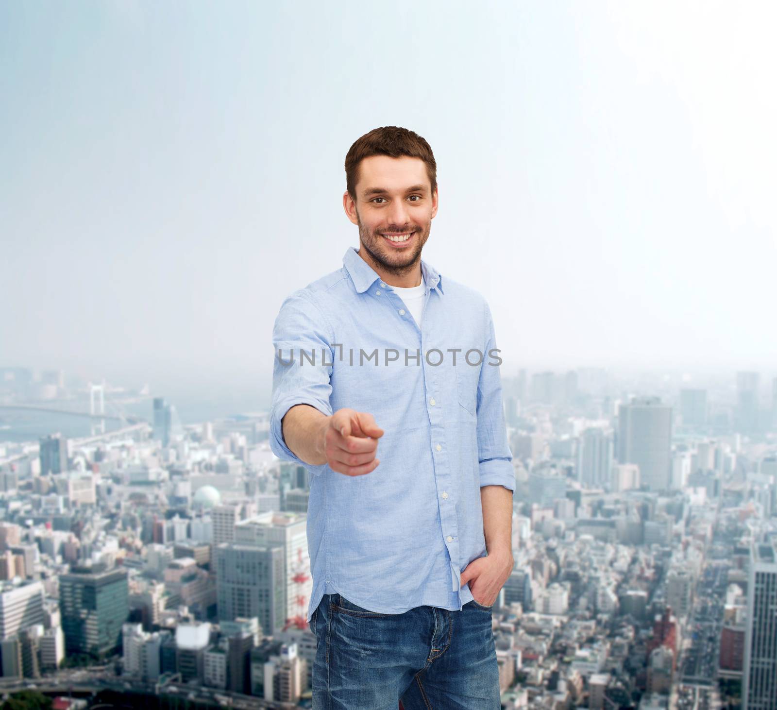 smiling man pointing finger at you by dolgachov