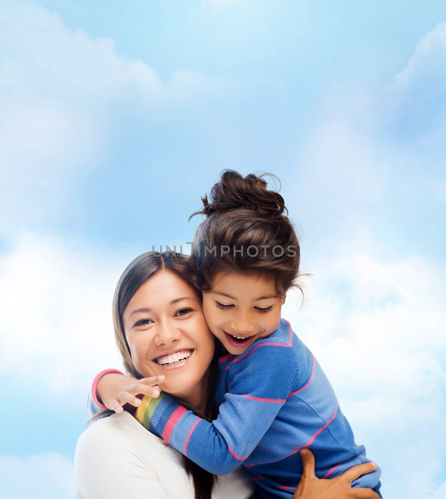 family, children and happy people concept - hugging mother and daughter