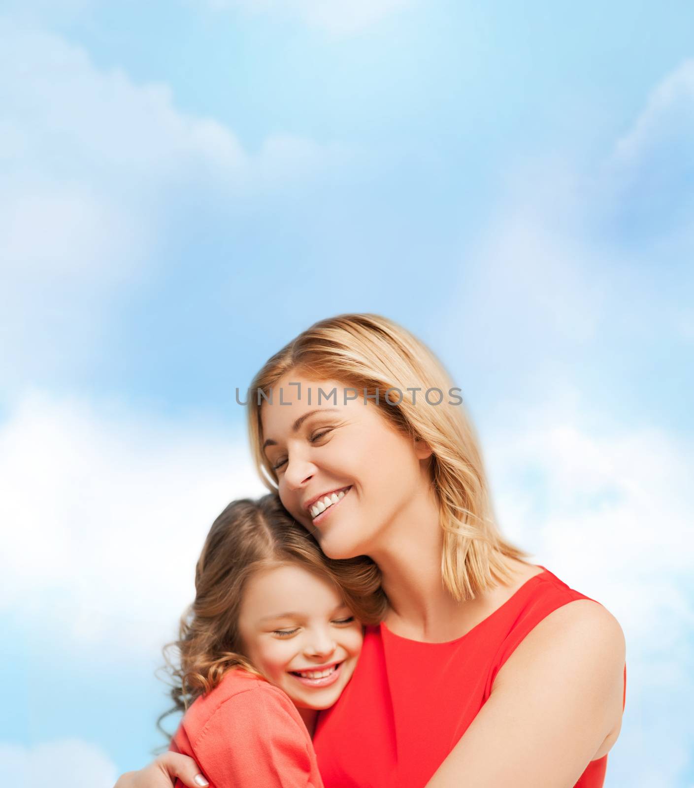 family, child and happiness concept - hugging mother and daughter