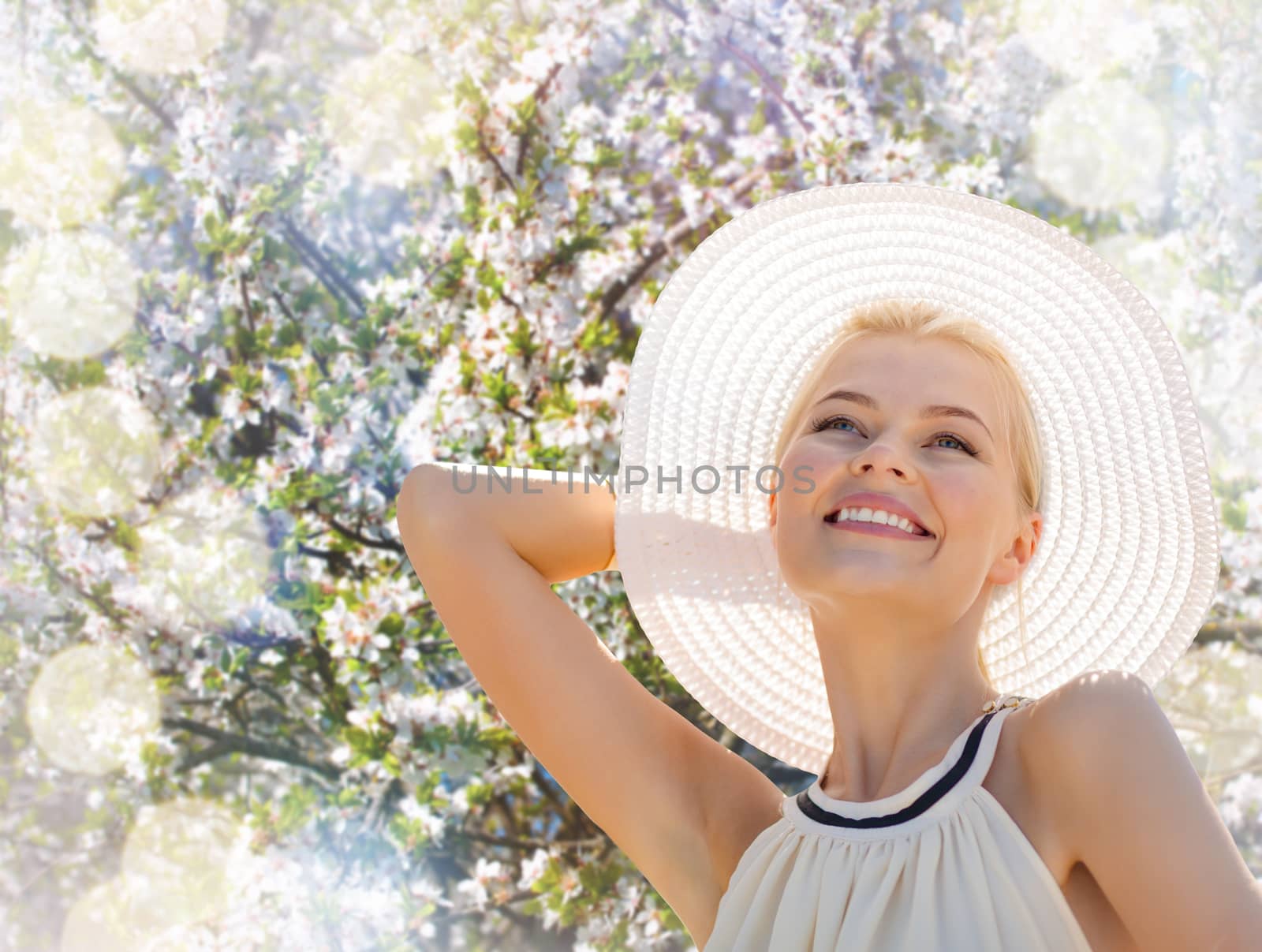 fashion, happiness and lifestyle concept - beautiful woman in hat enjoying summer outdoors