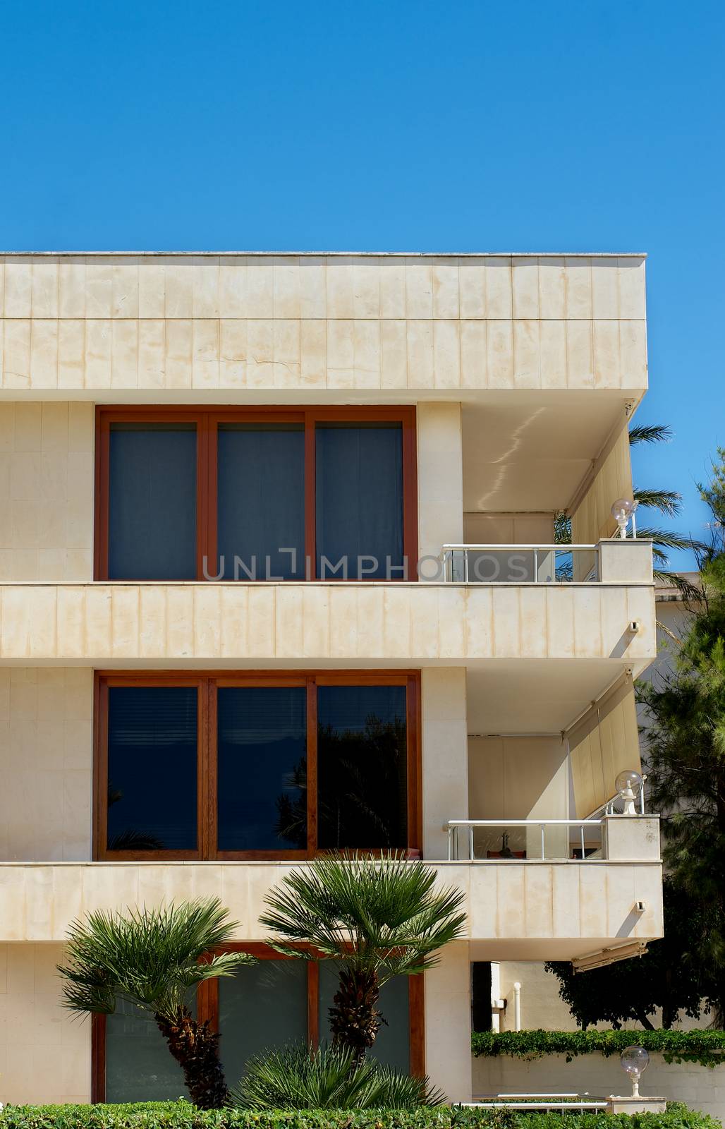 Modern Apartments with Big Windows and Balcony on Blue Sky background Outdoors