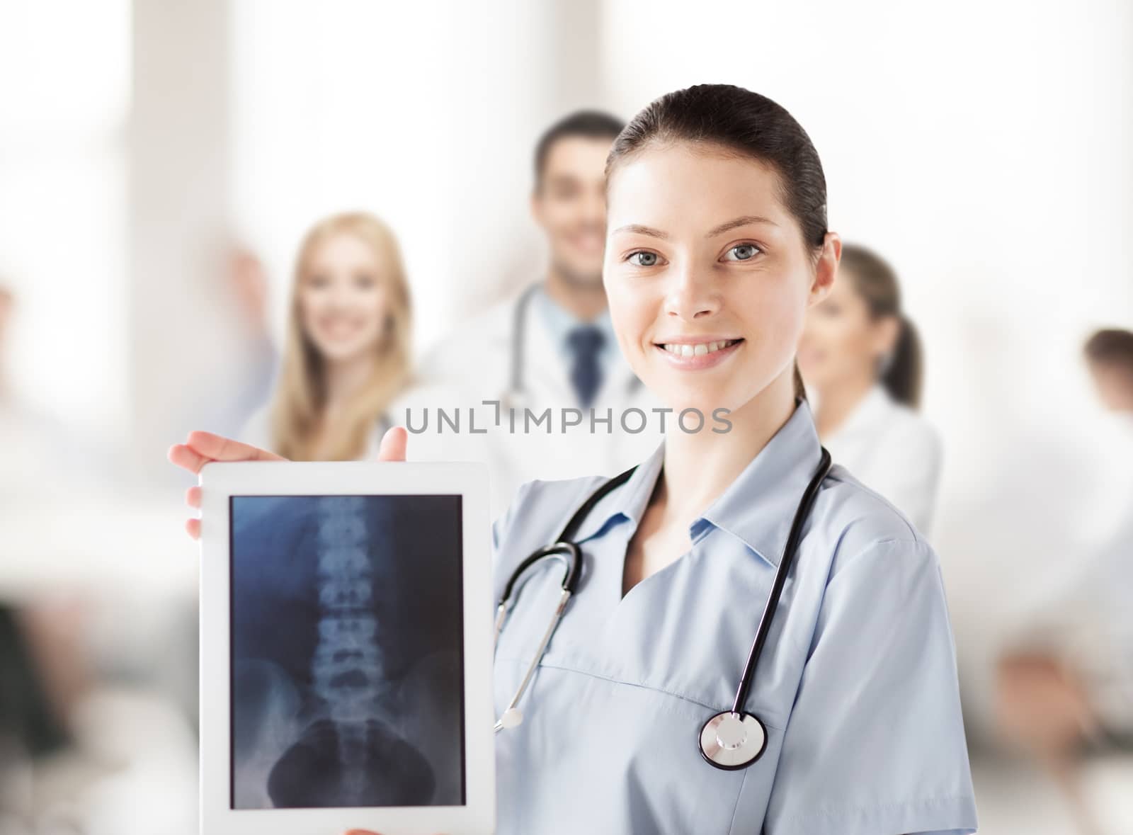 healthcare, medical and technology concept - female doctor with x-ray on tablet pc