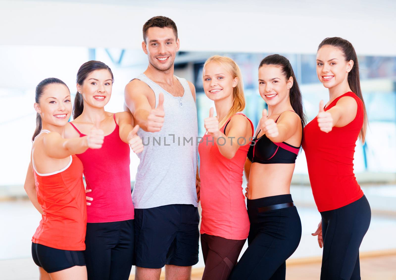 group of people in the gym showing thumbs up by dolgachov