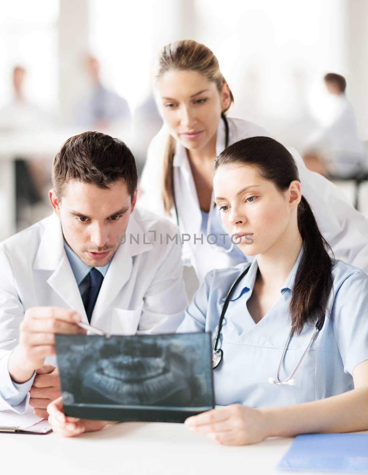 group of doctors looking at x-ray by dolgachov