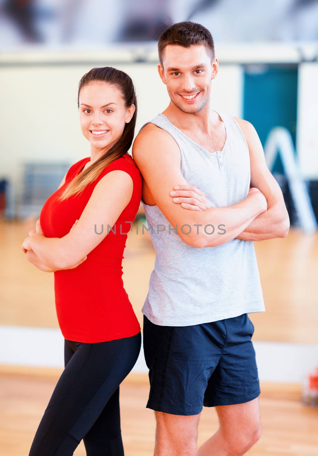 two smiling people in the gym by dolgachov