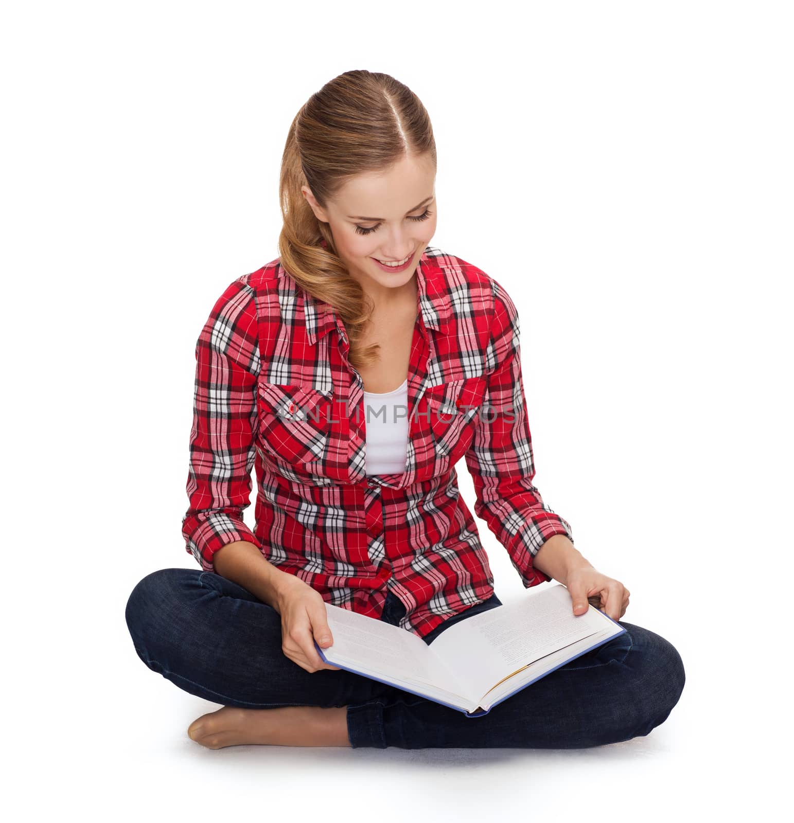 smiling young woman sitting on floor with book by dolgachov