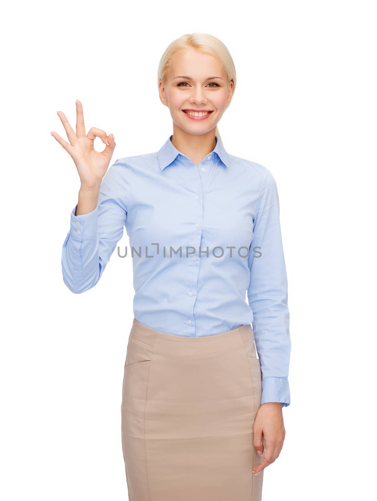 smiling businesswoman showing ok-sign with hand by dolgachov