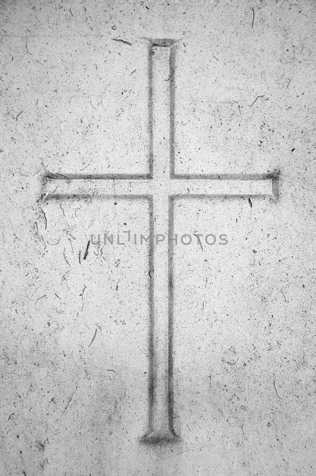 Religion conceptual image. Cross carved in stone