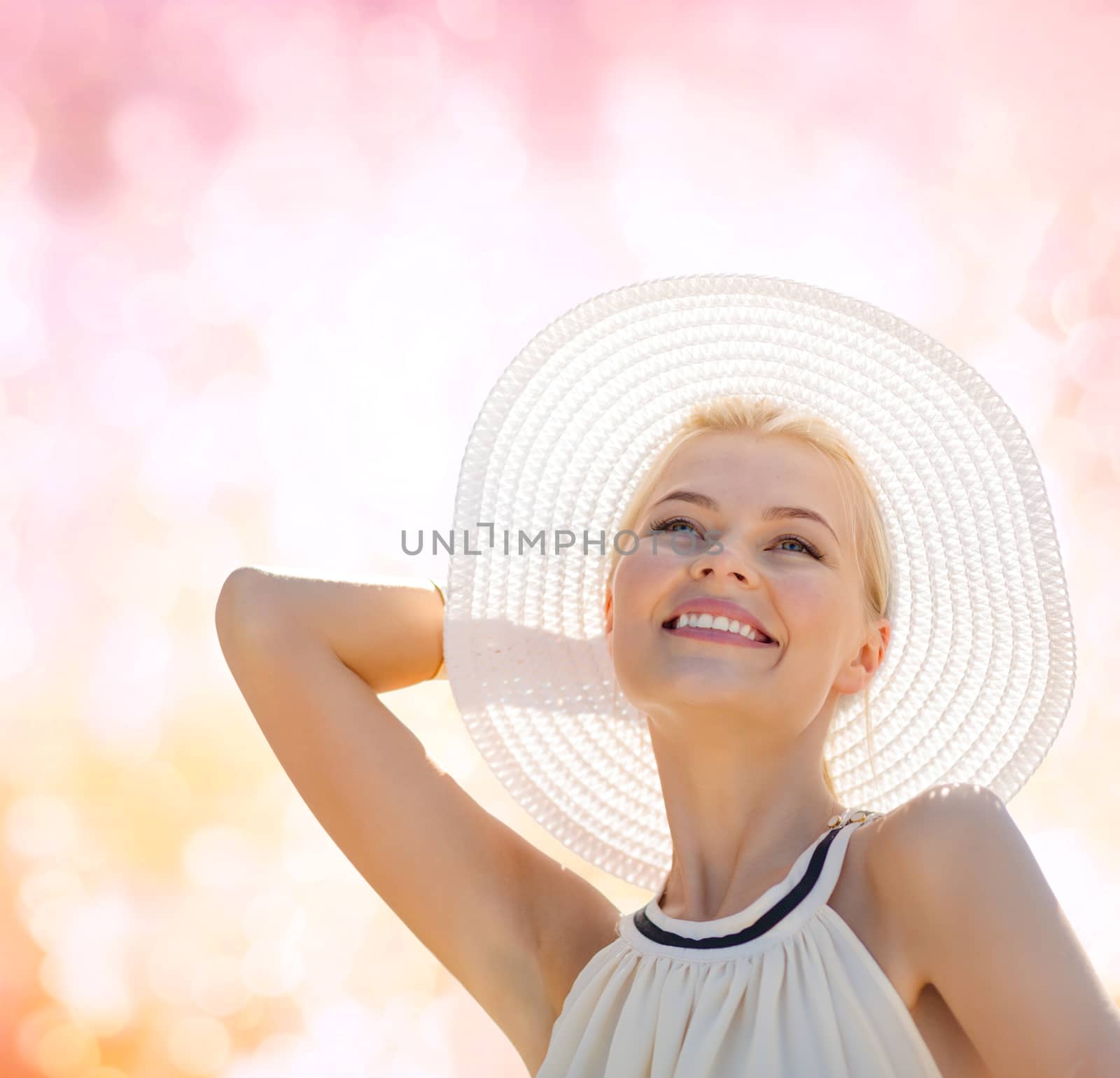 fashion, happiness and lifestyle concept - beautiful woman in hat enjoying summer outdoors