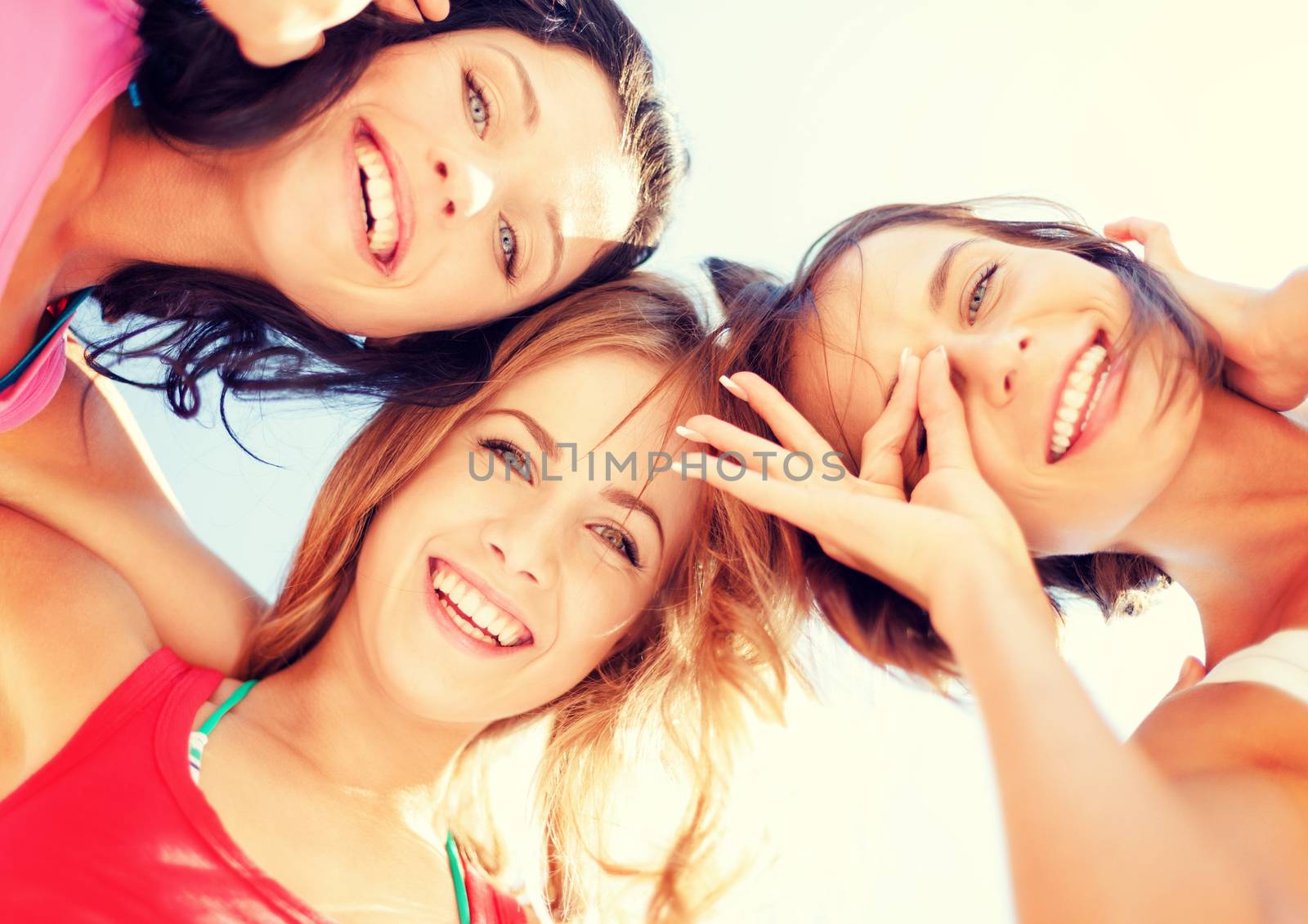 summer holidays and vacation - girls faces with shades looking down