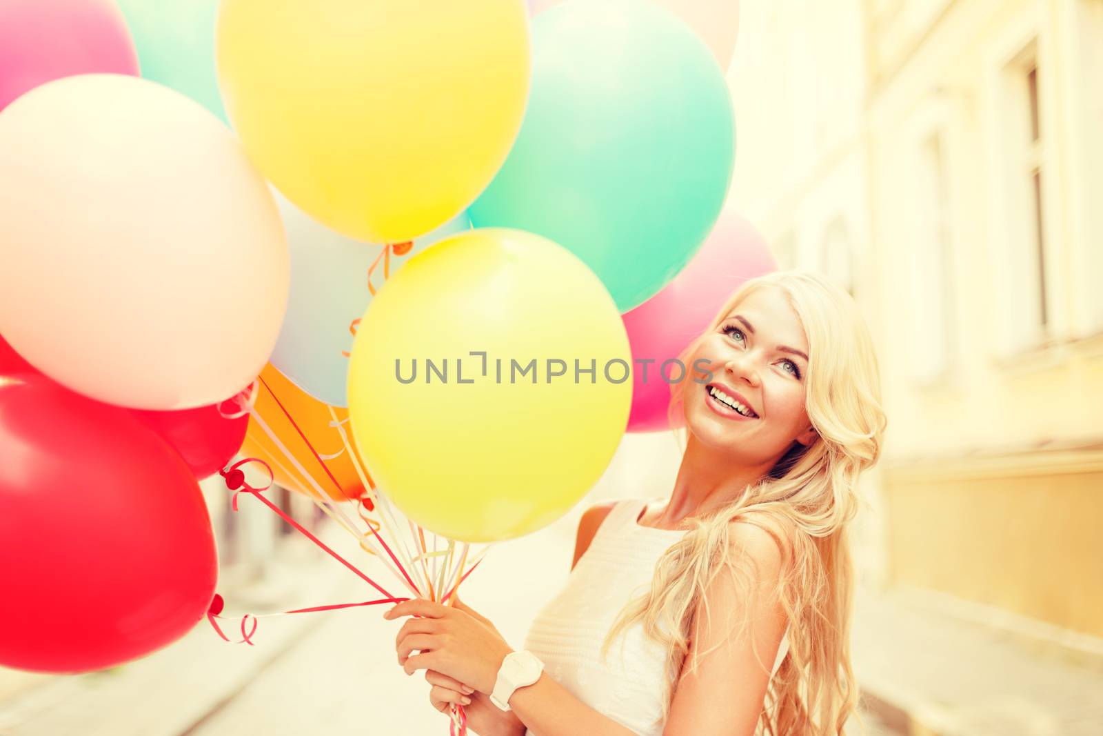 summer holidays, celebration and lifestyle concept - beautiful woman with colorful balloons in the city