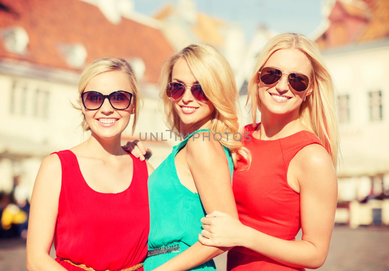 holidays and tourism, friends, hen party, blonde girls concept - three beautiful women in the city
