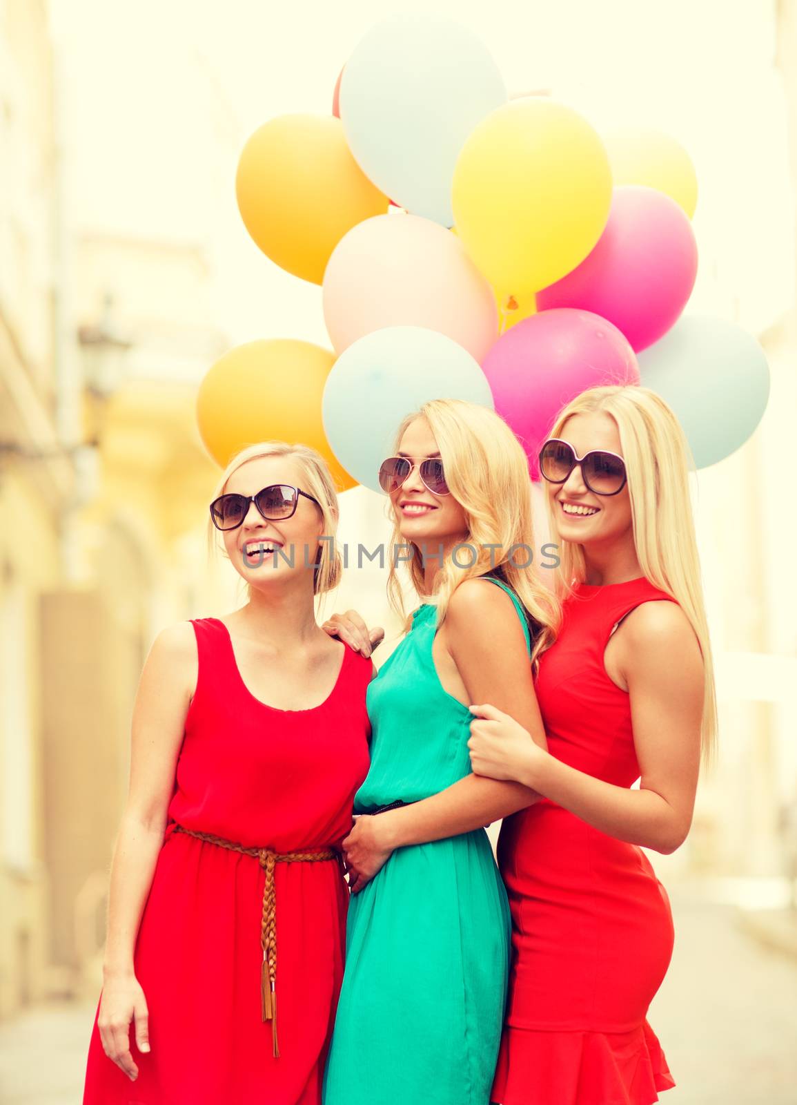 holidays and tourism, friends, hen party, blonde girls concept - three beautiful women with colorful balloons in the city