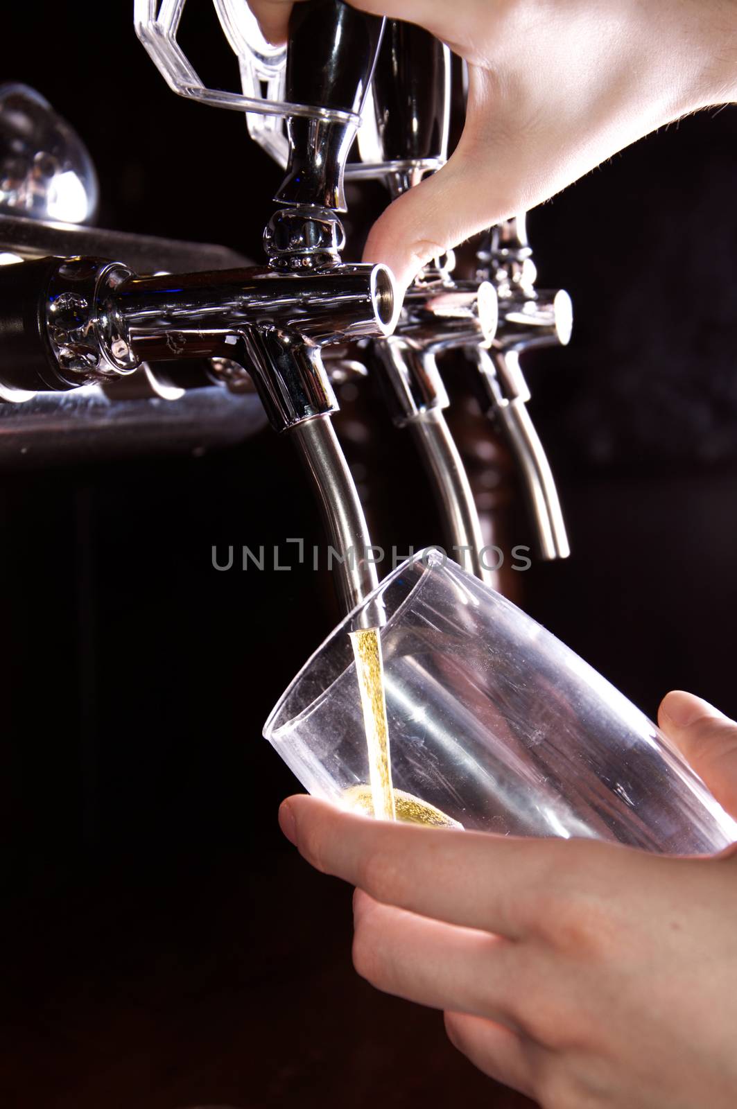 Alcohol conceptual image. Bartender giving the beer from dispenser.