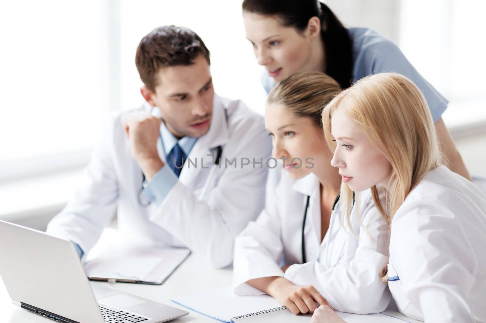 group of doctors looking at tablet pc by dolgachov