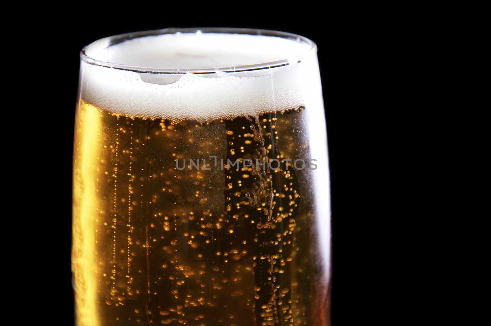 Alcohol conceptual image. Mug full of beer on black background.