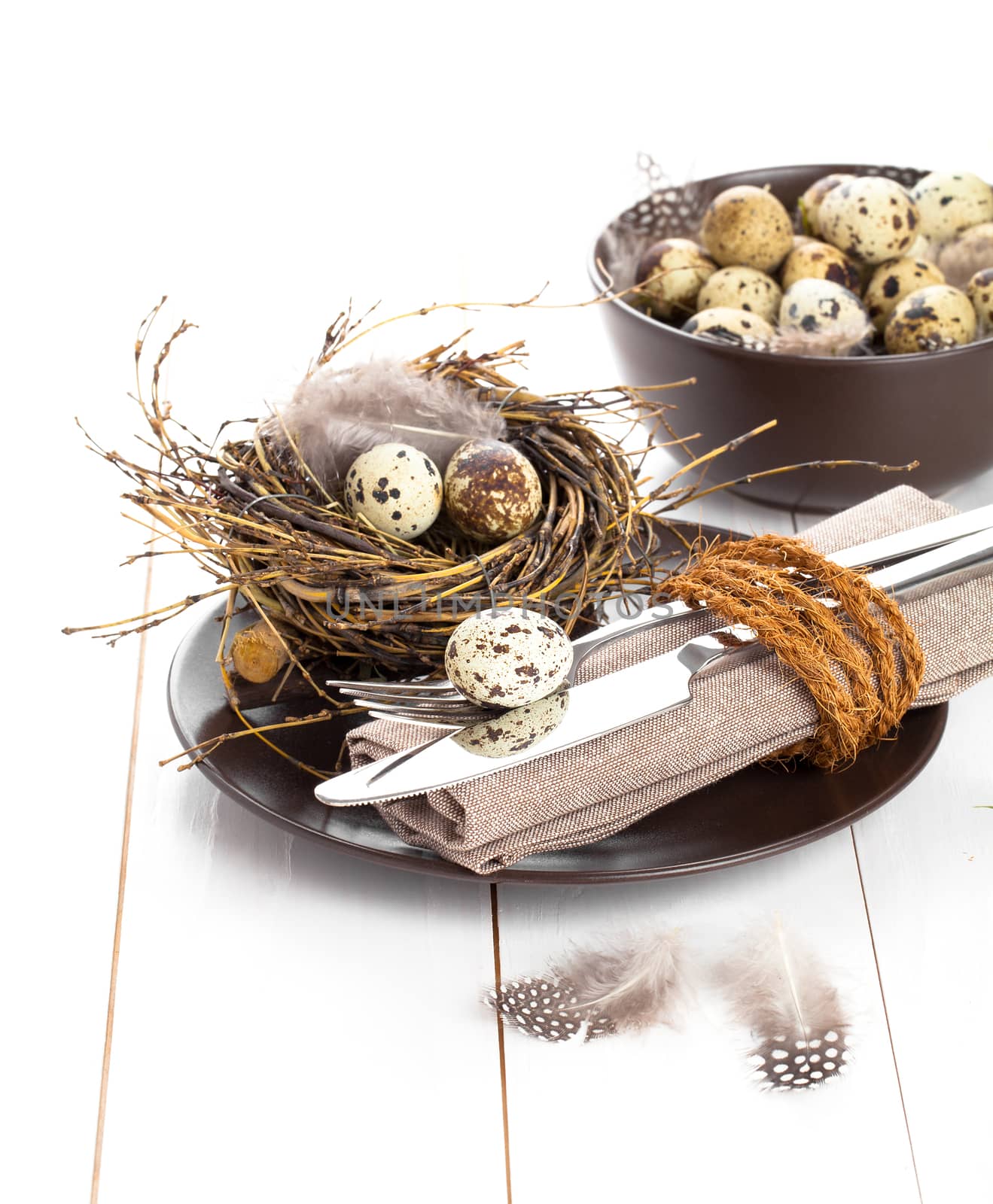 table decoration on white wooden background with quail eggs by motorolka