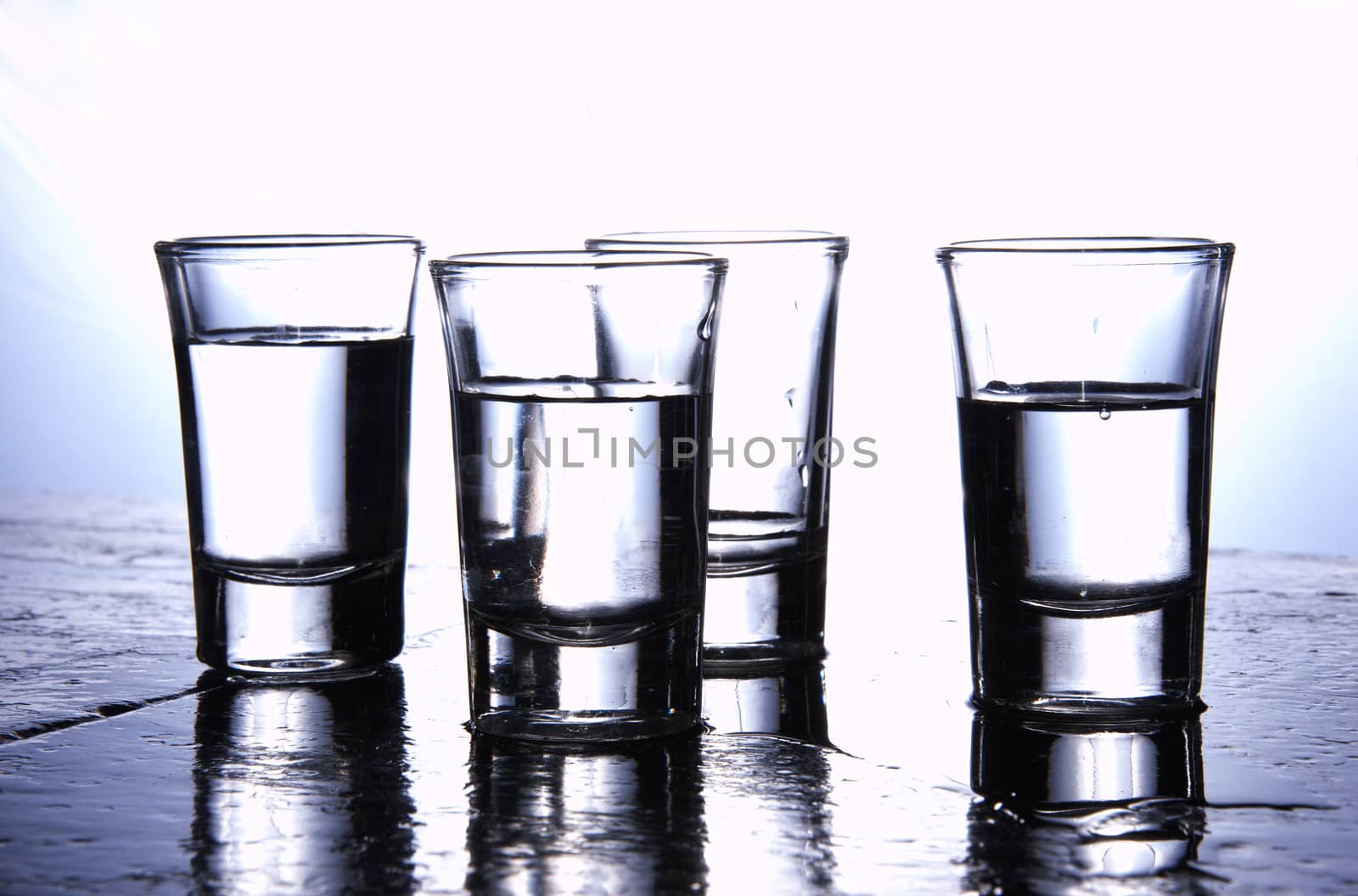 Alcohol conceptual image. Glasses of pure vodka.