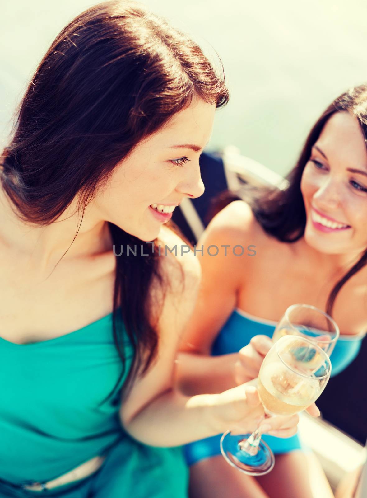 girls with champagne glasses on boat by dolgachov