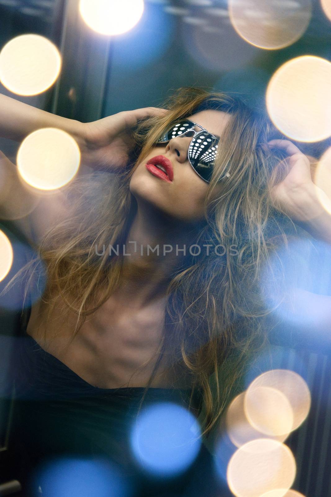 fashion and people concept - beautiful woman in sunglasses in elevator