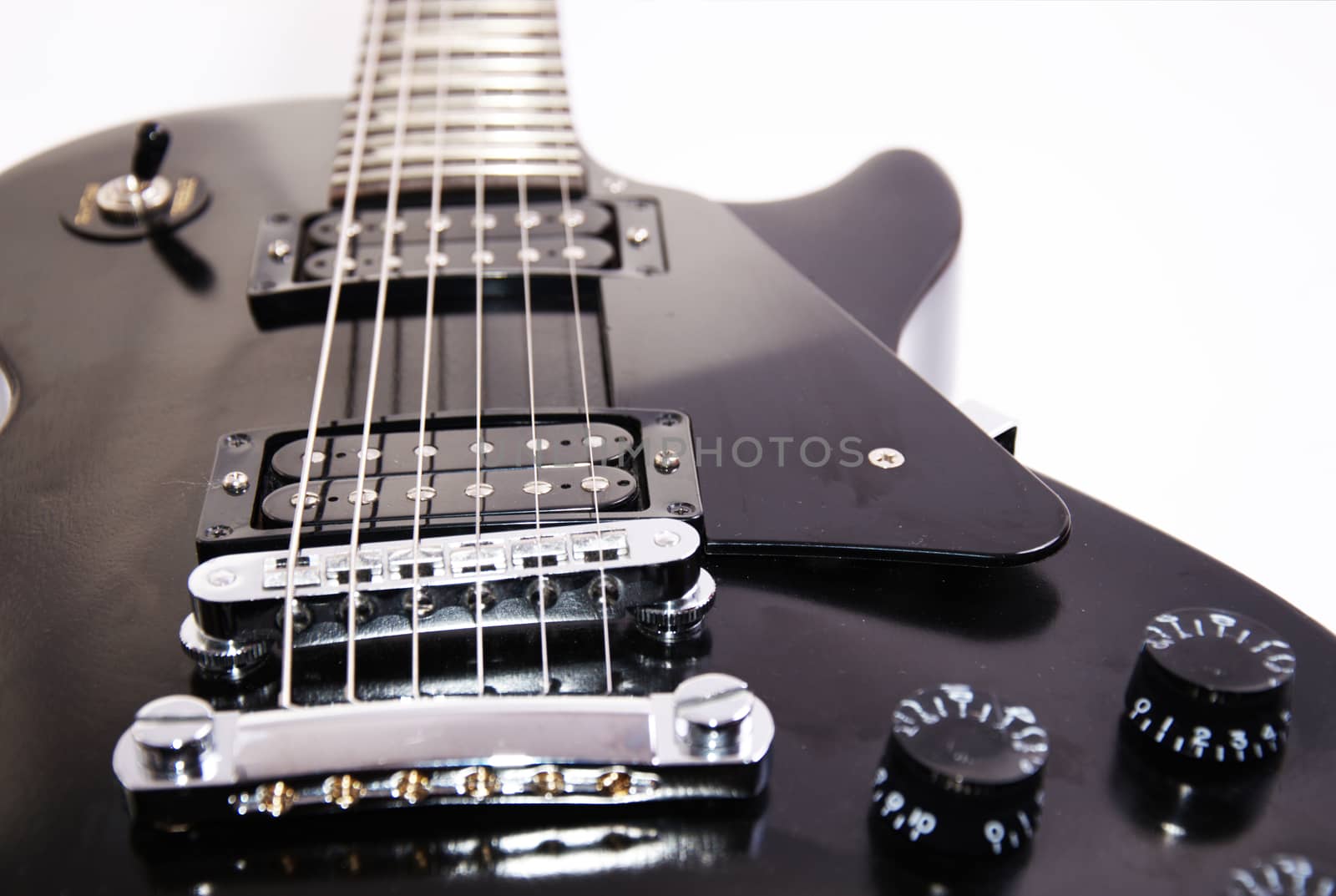 Music conceptual image. Black electric guitar on isolated background.