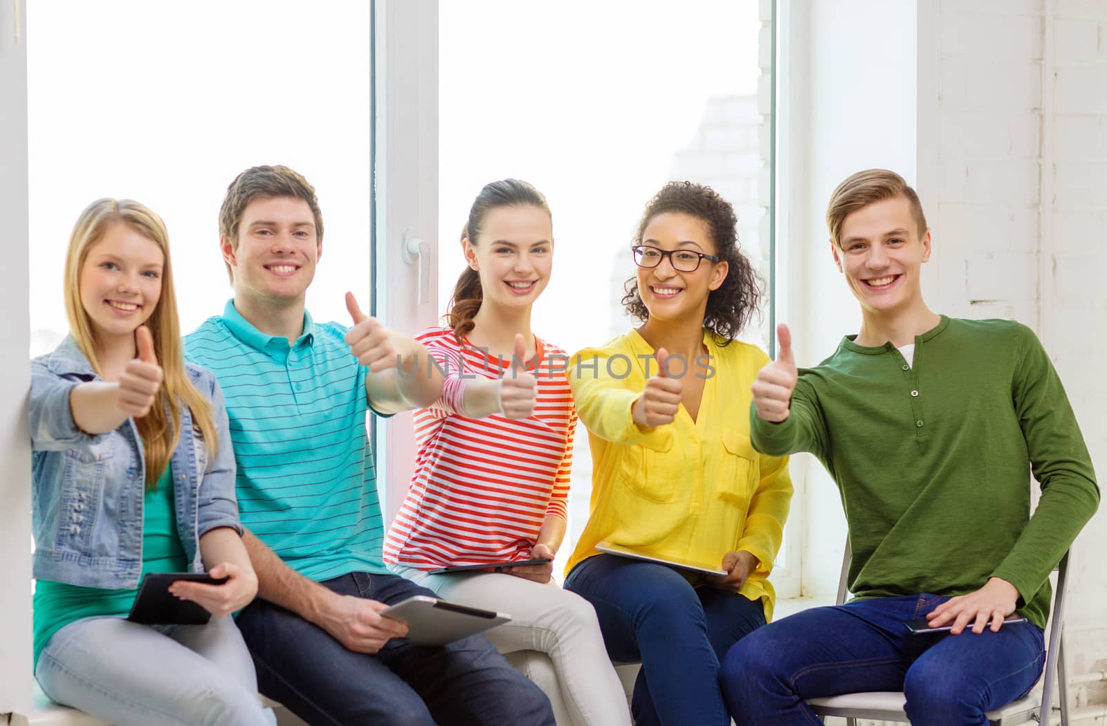 smiling students with tablet pc computer by dolgachov