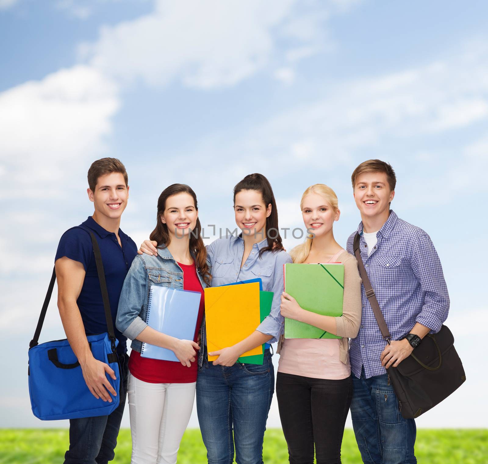 education and people concept - group of smiling students standing