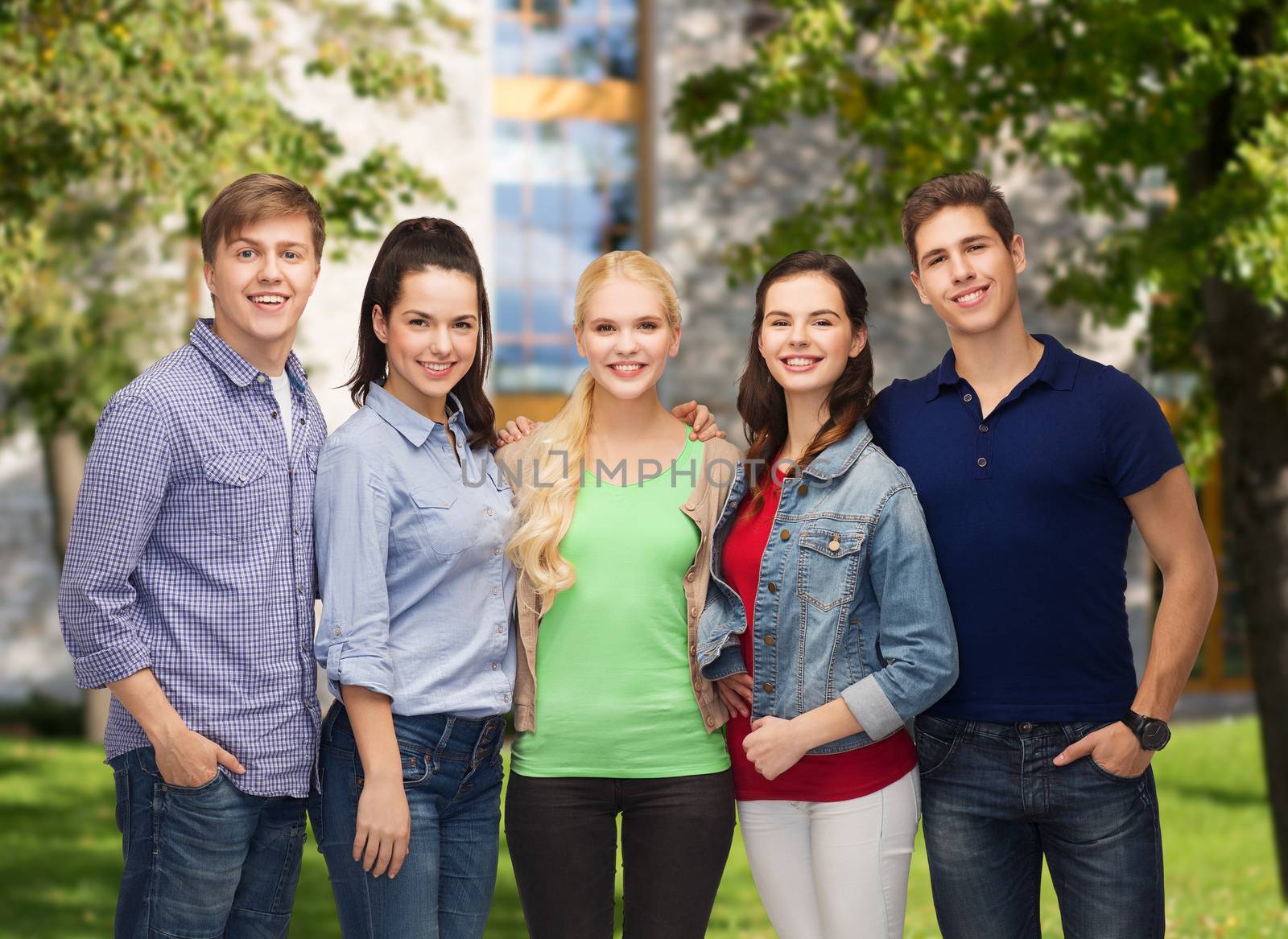 education and people concept - group of standing smiling students