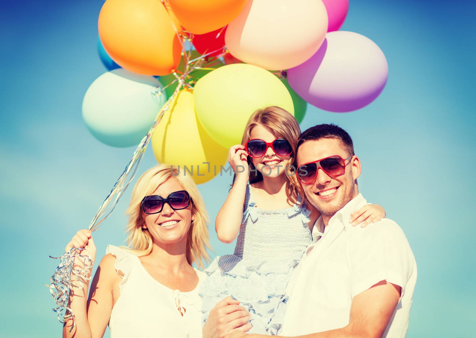 summer holidays, celebration, children and people concept - family with colorful balloons