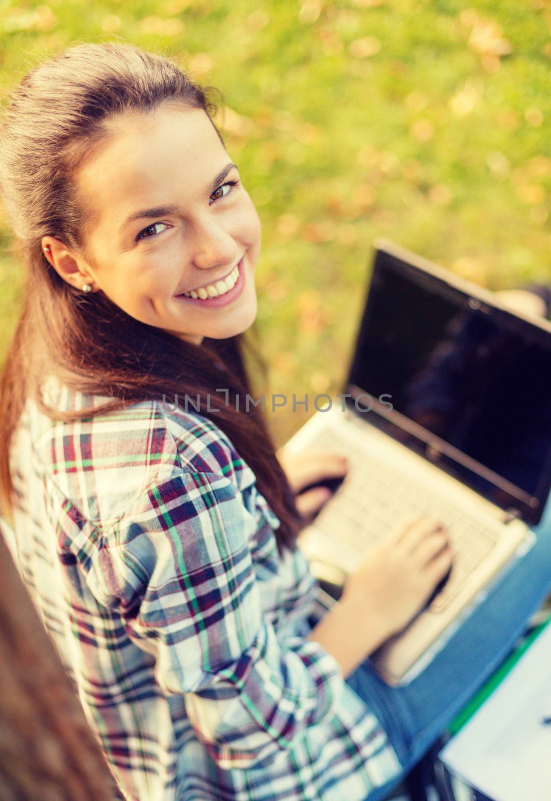 smiling teenager with laptop by dolgachov