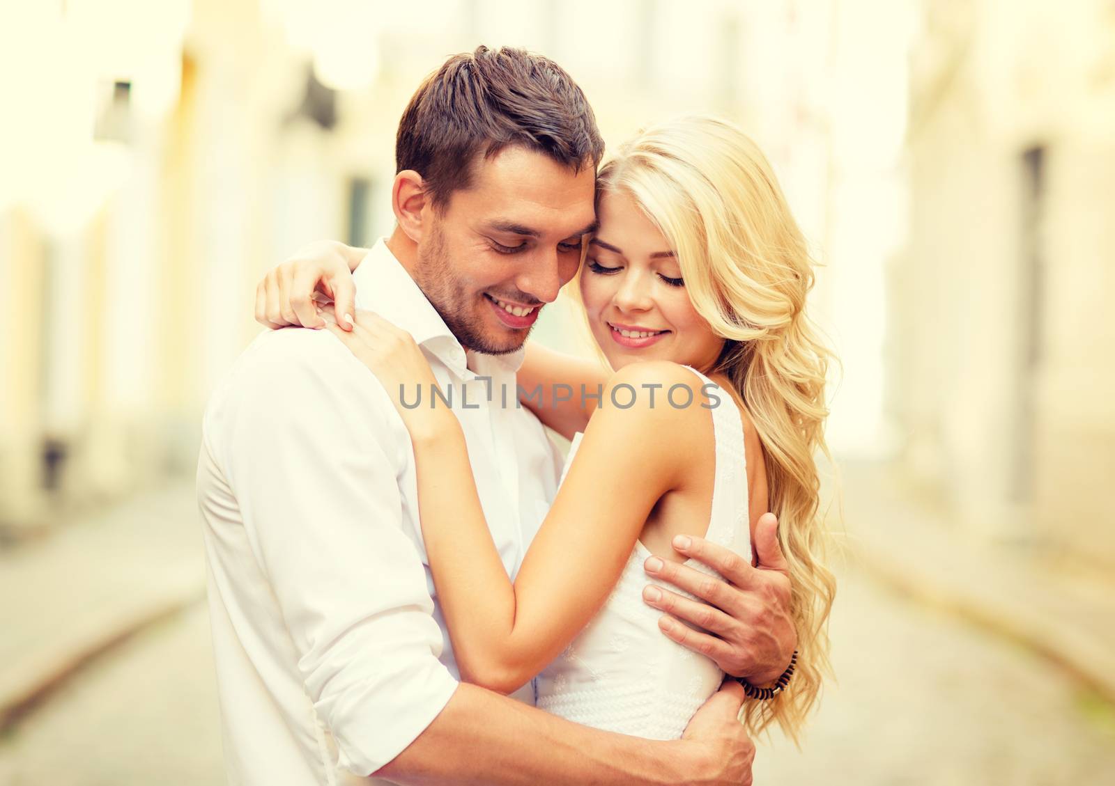 summer holidays, love, travel, tourism, relationship and dating concept - romantic happy couple hugging in the street