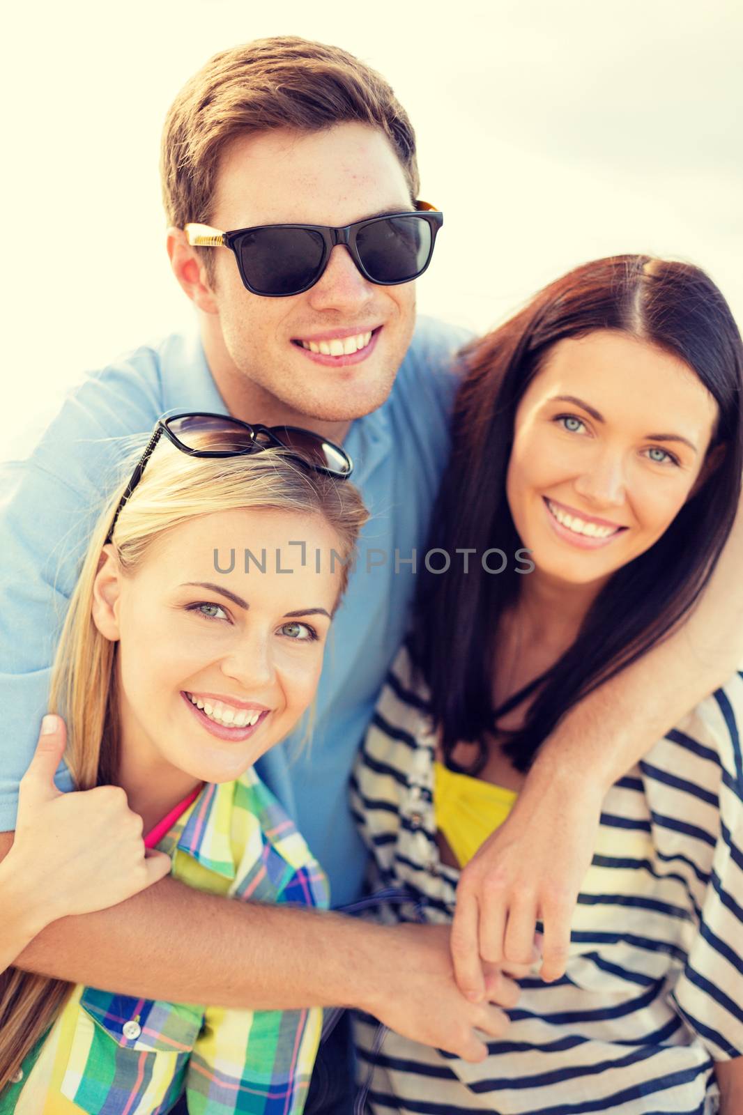 group of friends having fun on the beach by dolgachov