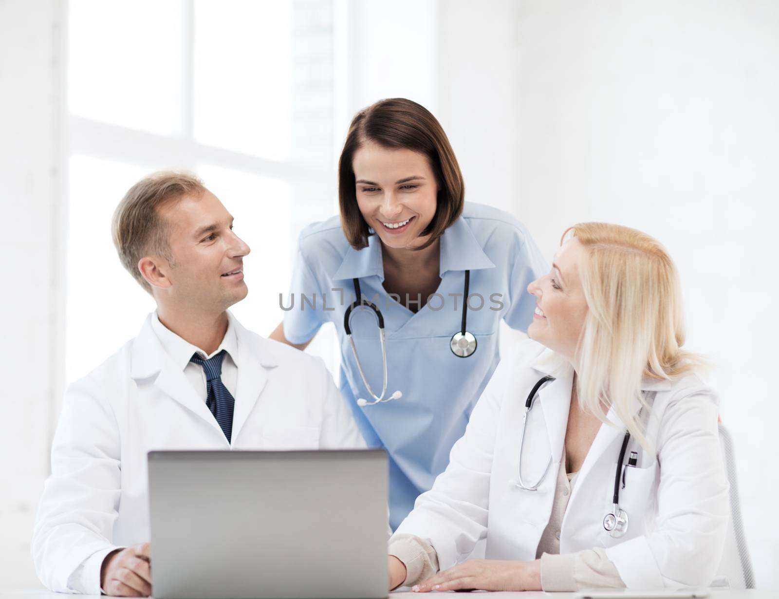 group of doctors looking at tablet pc by dolgachov