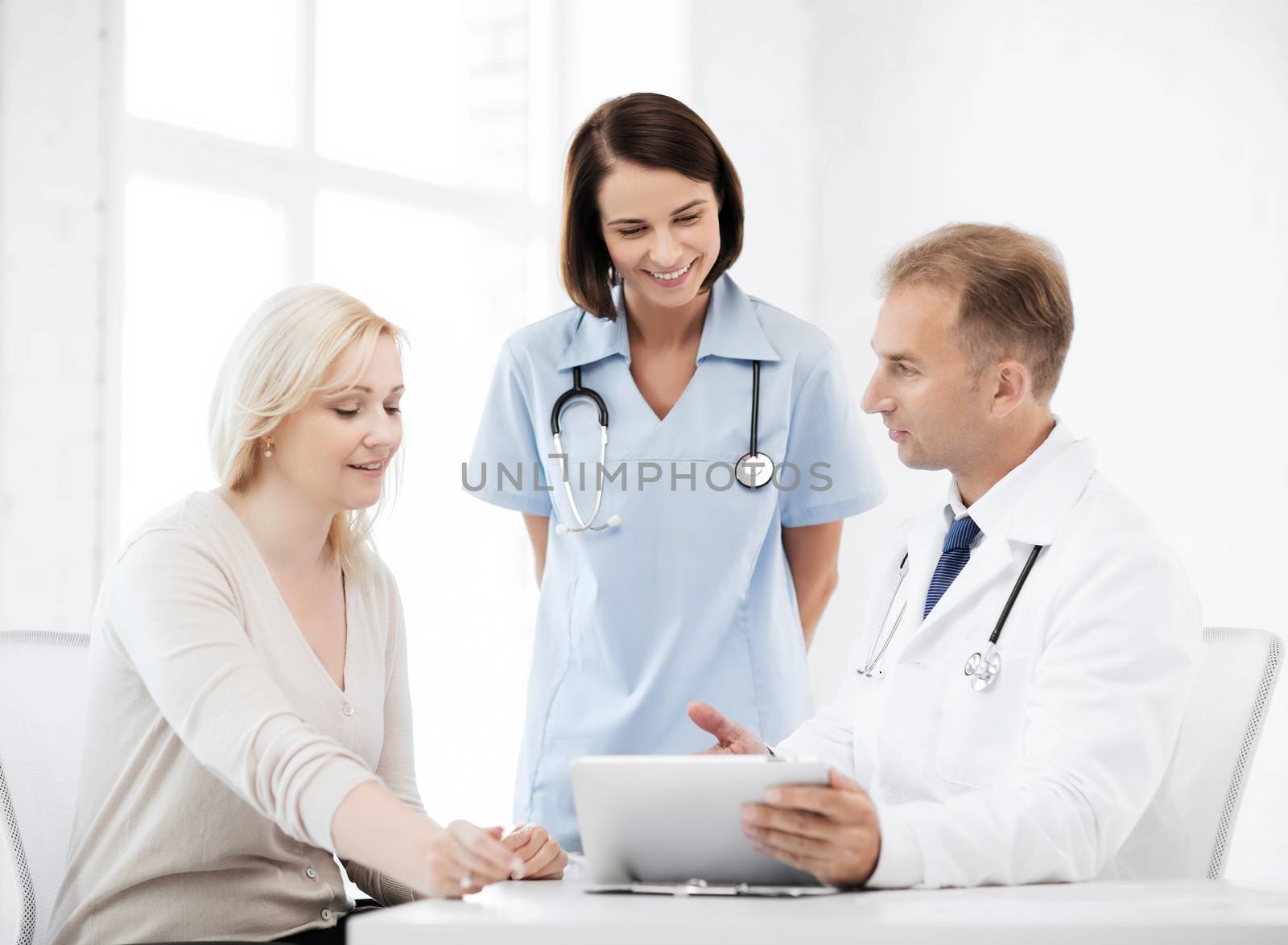 healthcare, medical and technology - doctor showing something to patient on tablet pc