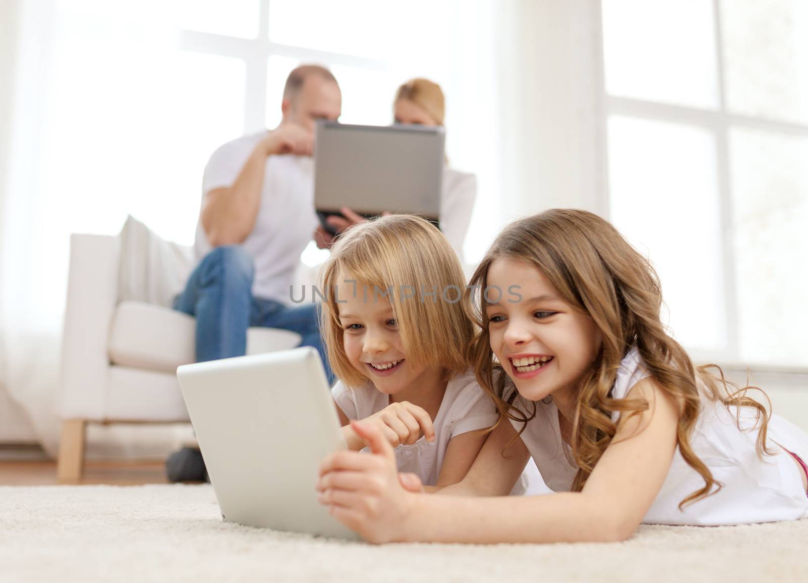 smiling sister with tablet pc and parents on back by dolgachov