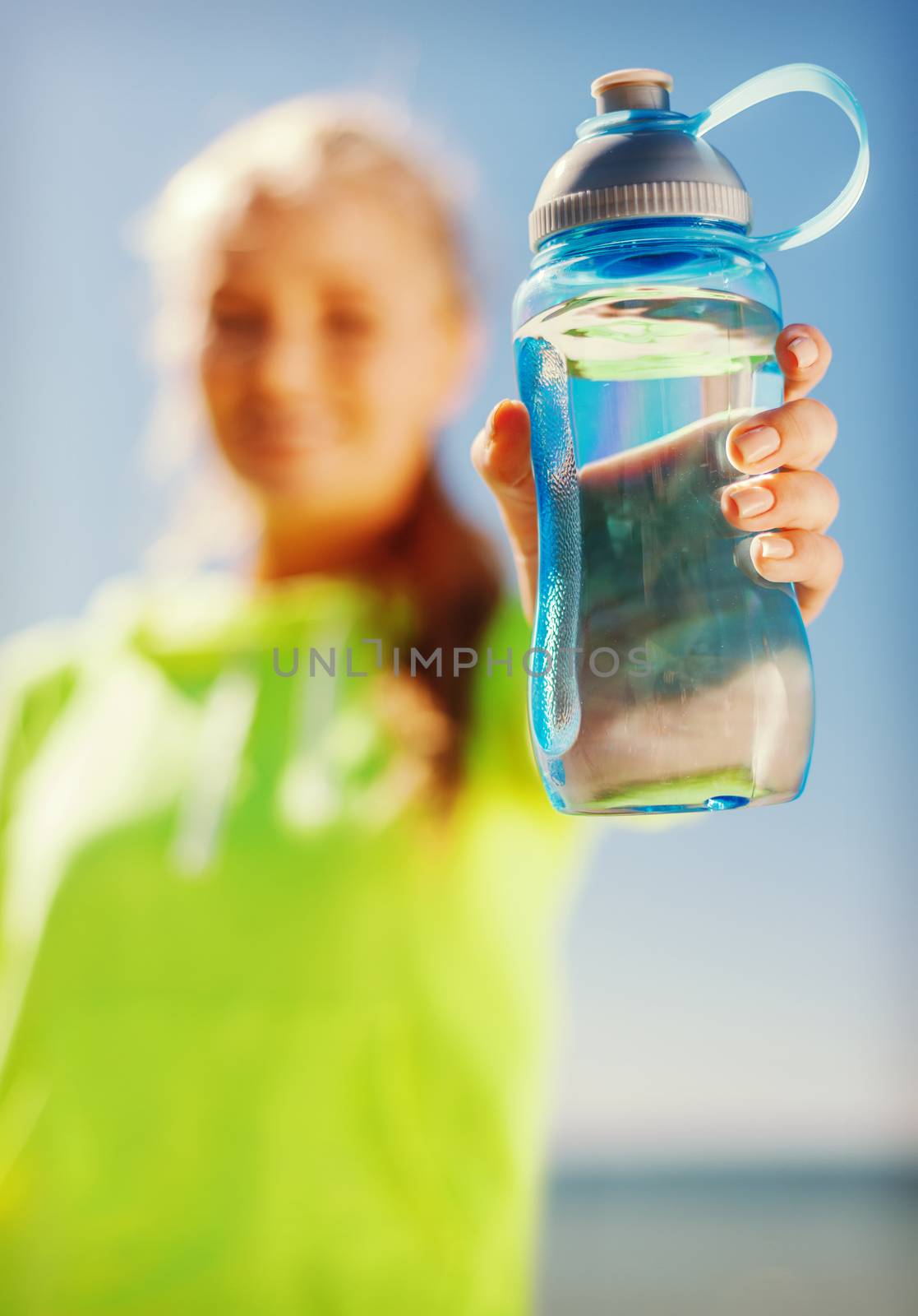 woman showing a bottle of water by dolgachov