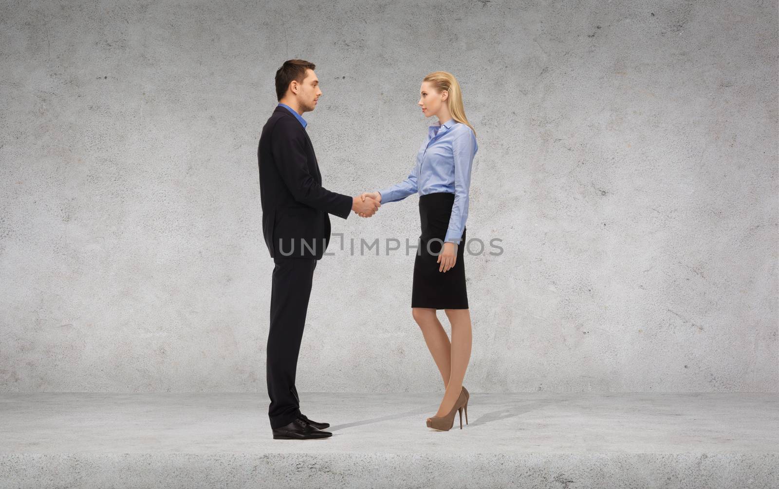 businessman and businesswoman shaking hands by dolgachov