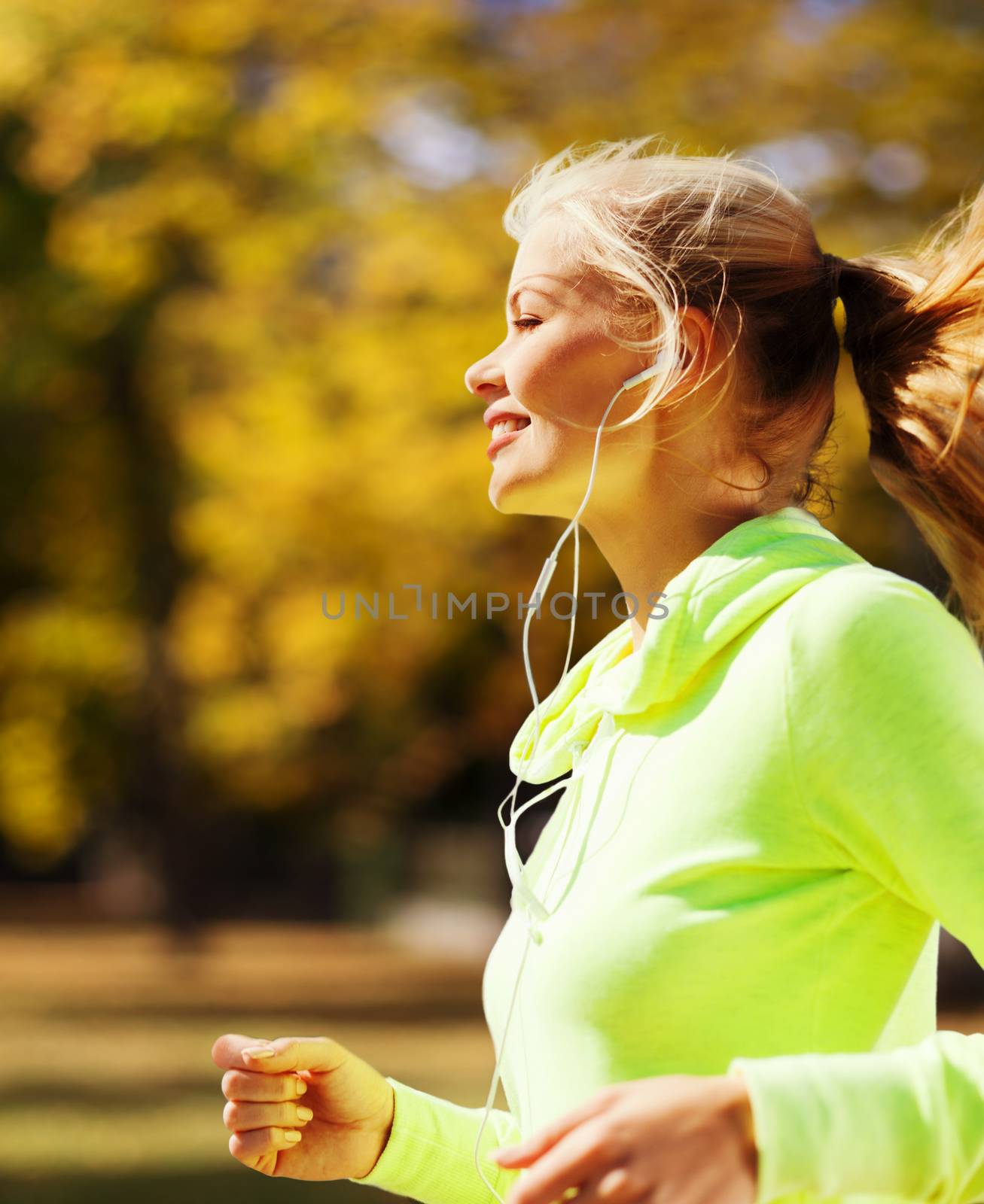 sport and lifestyle concept - woman doing running outdoors