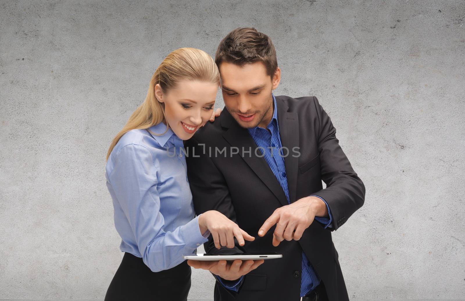 business, technology and office concept - smiling businesswoman and businessman looking at tablet pc computer