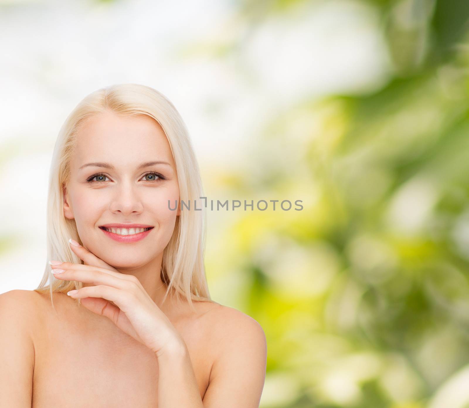 health and beauty concept - face and hands of beautiful woman