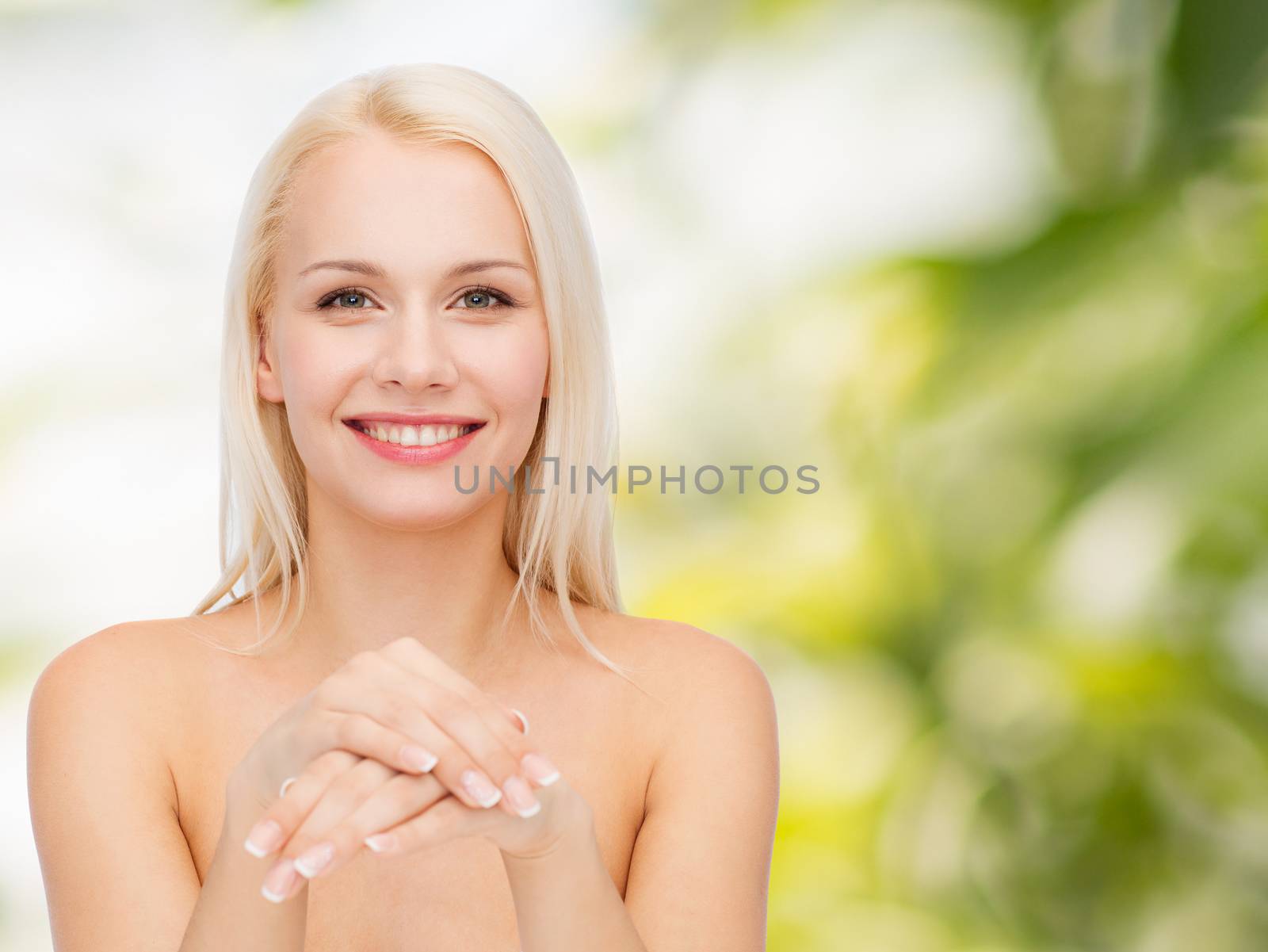 health and beauty concept - face and hands of beautiful woman