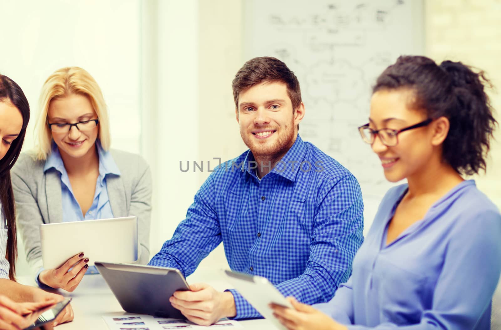 smiling team with table pc and papers working by dolgachov