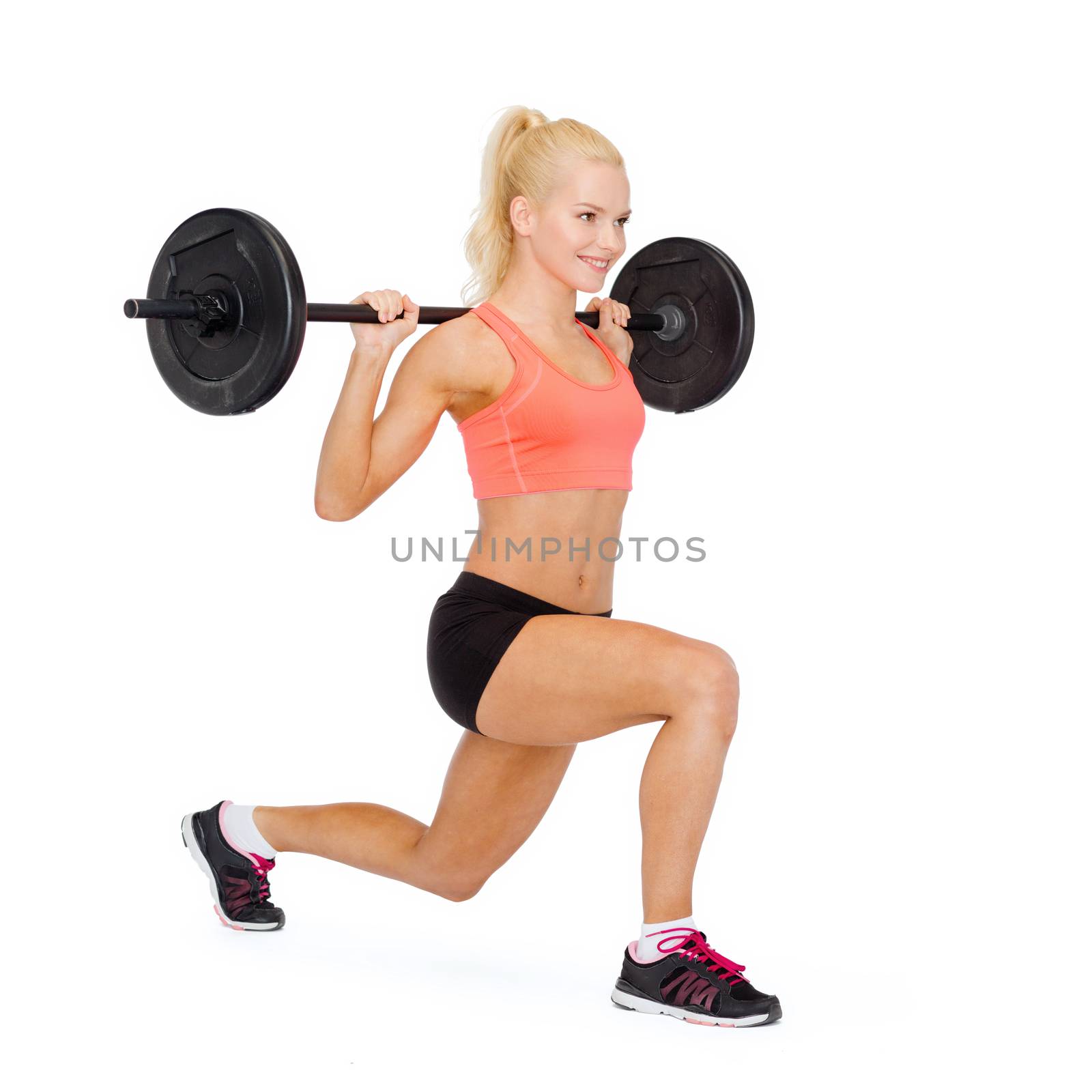 smiling sporty woman exercising with barbell by dolgachov