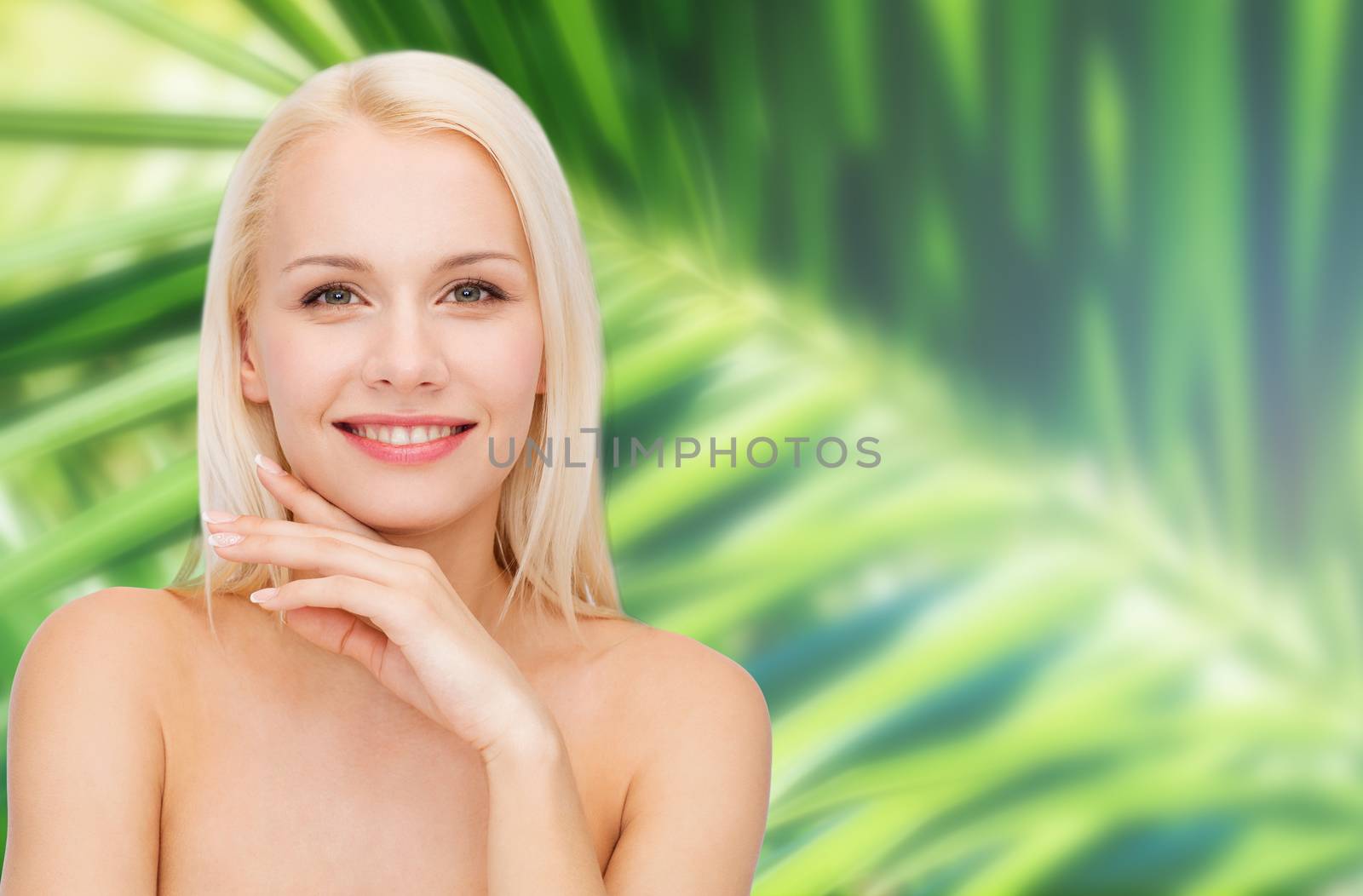 health and beauty concept - face and hands of beautiful woman