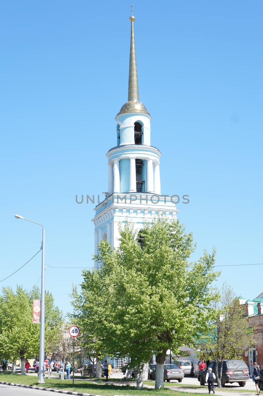 The steeple of the church against the blue sky