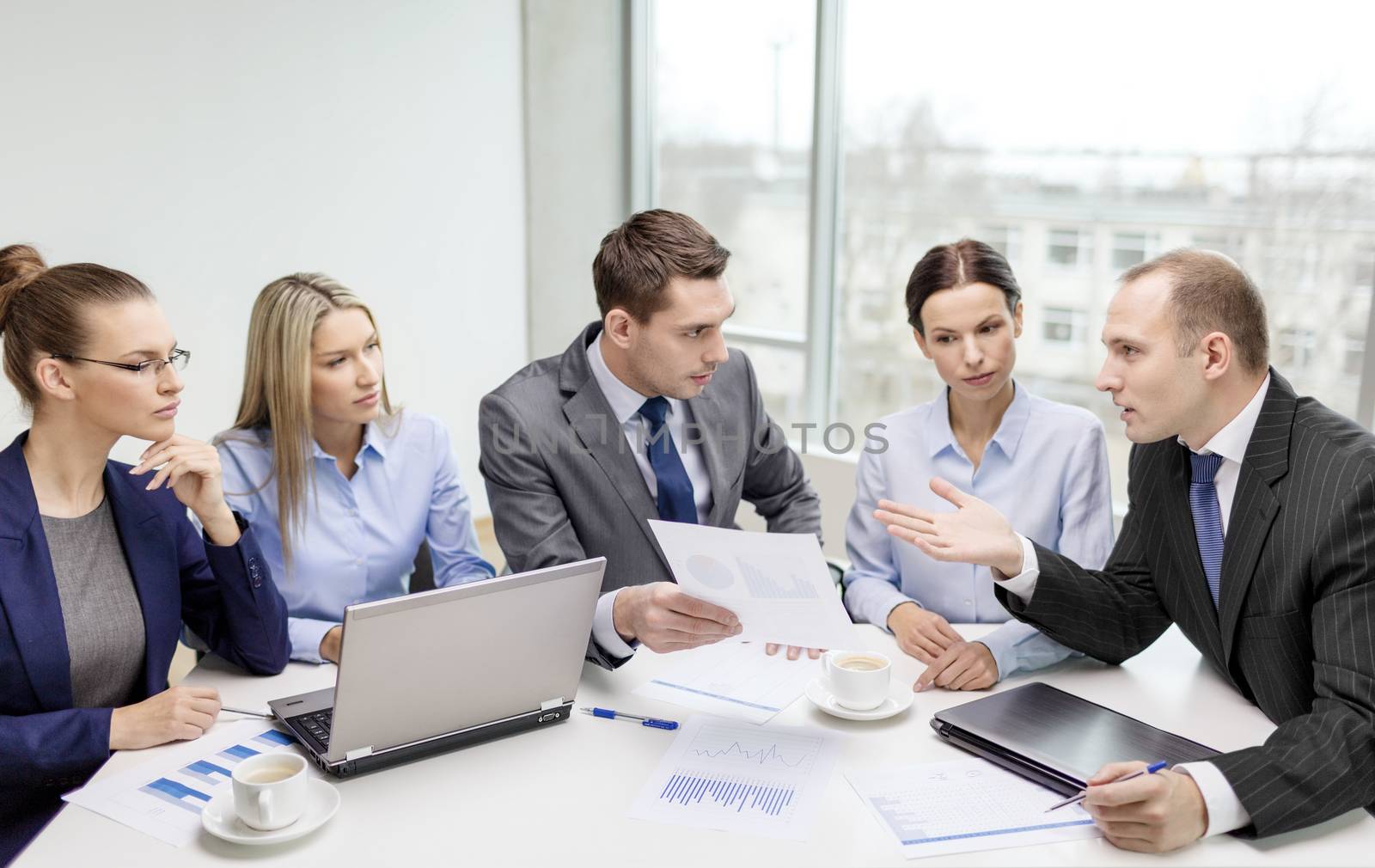 business team with laptop having discussion by dolgachov