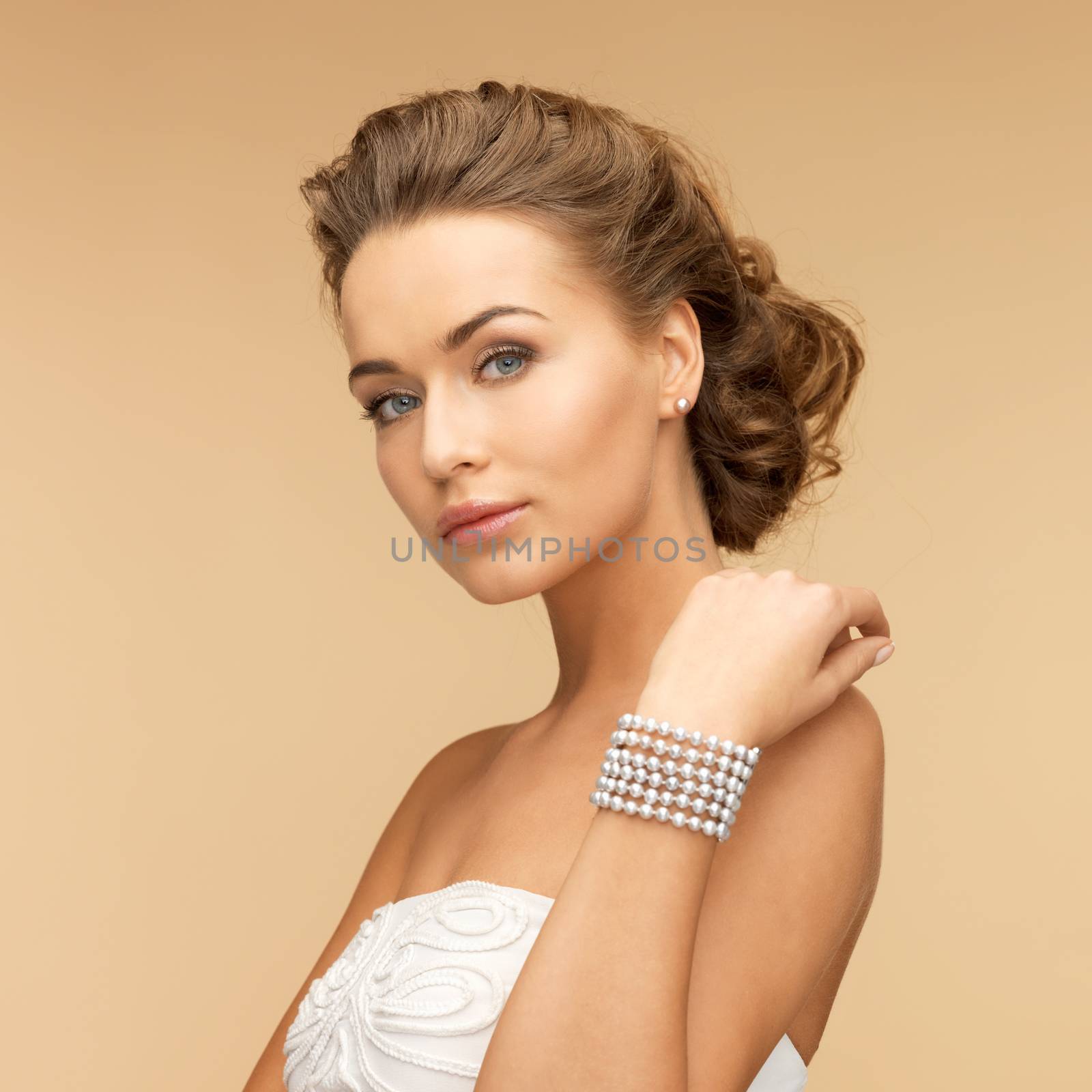 woman with pearl earrings and bracelet by dolgachov
